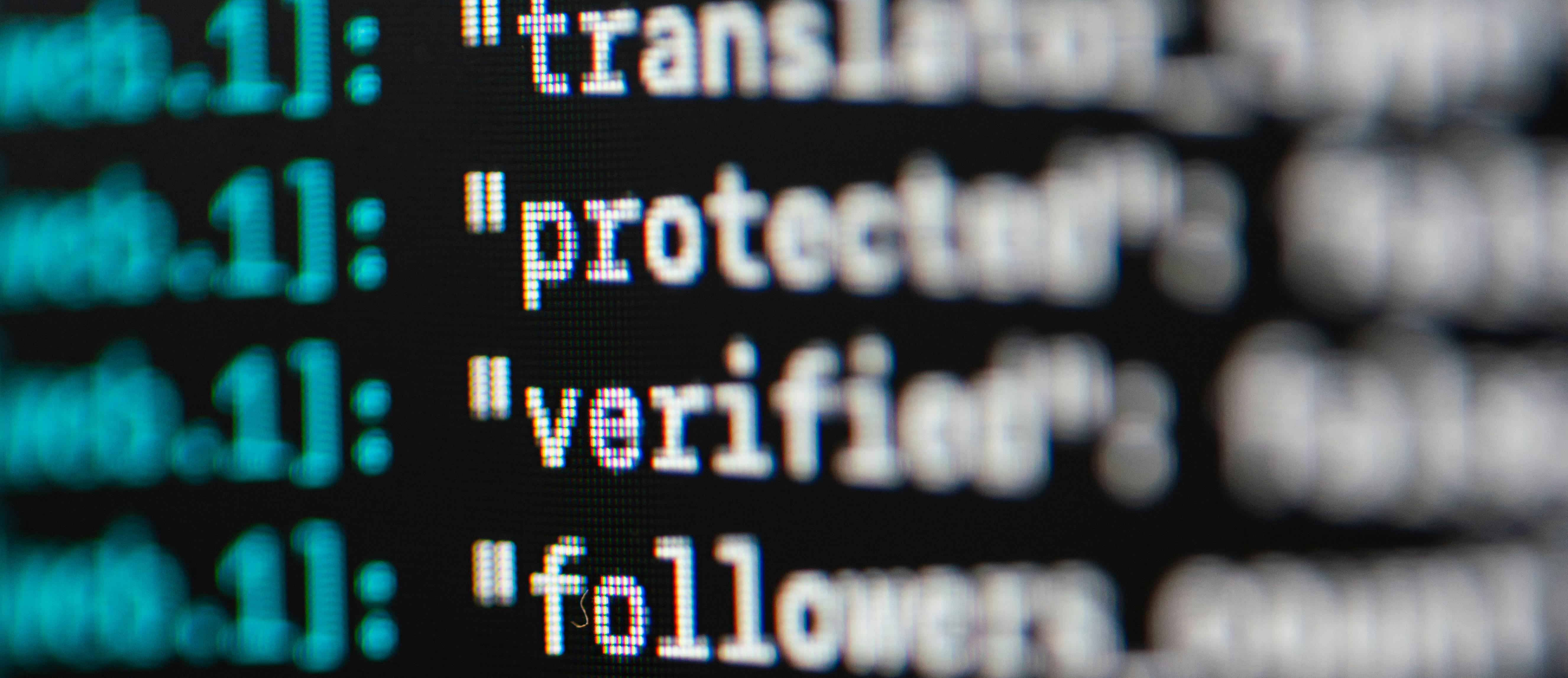 Close-up photo of codes on screen showing technical data and programming interface